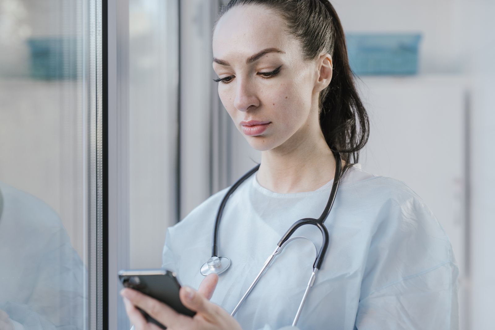 Doctor using a smartphone, representing a doctor personal brand online